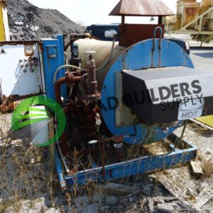 Industrial machinery with rust and vegetation around.