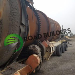 Rusty industrial equipment on gravel surface.