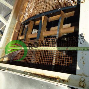 Rusty metal grating with measuring tape.