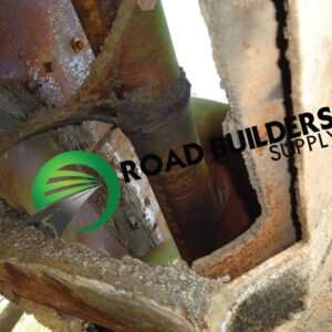 Rusty metal structure with Road Builders Supply logo.