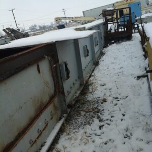 Snow-covered industrial equipment in outdoor setting.