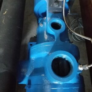 Blue industrial machinery component with pipes attached.