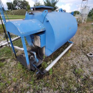 Blue industrial tank on gravel ground.