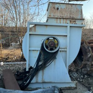 Rusty industrial machinery outdoors in scrapyard.