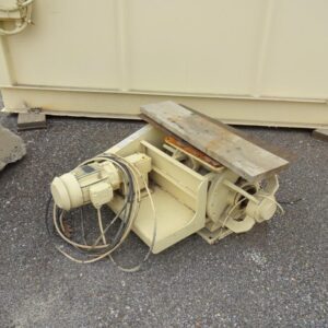 Industrial equipment with motor and cables outdoors.