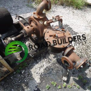 Rusty industrial pump assembly on gravel