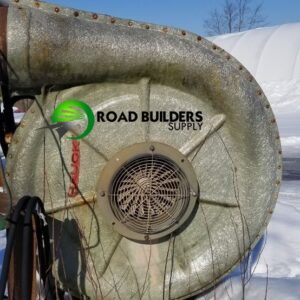 Industrial fan outdoors in snowy setting.