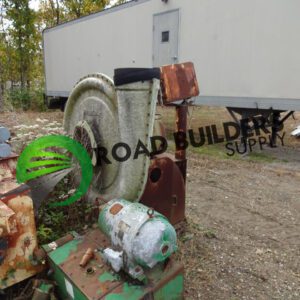 Old machinery near a trailer outdoors.