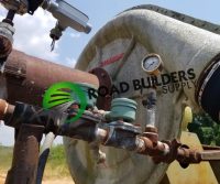 Industrial machinery with gauges and pipes outdoors.