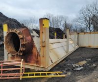 Rusty industrial equipment on muddy construction site.