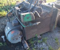 Rusty industrial equipment on gravel ground.
