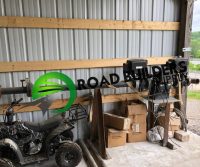 Workshop with equipment and boxes inside shed.