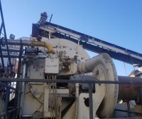 Industrial machinery against a clear blue sky.