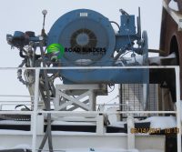 Industrial machinery with snow and railing.