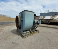 Industrial fan on concrete surface outdoors.