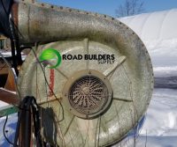 Industrial fan outdoors in snowy setting.