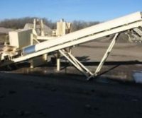 Conveyor system in an industrial outdoor setting.