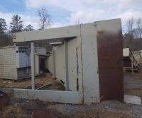 Large rusted metal structure on ground.