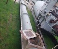 Industrial equipment lying on grass.