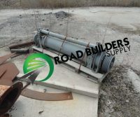 Construction equipment cylinder on wooden pallet.