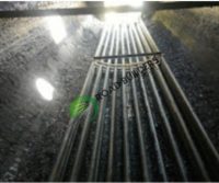 Metal pipes in a dimly lit tunnel.