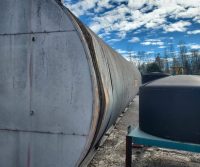 Large industrial tank under a cloudy sky.
