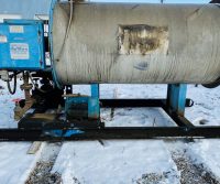 Industrial equipment on snowy ground outdoors.