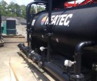 Industrial machinery with pipes and valves outdoors.