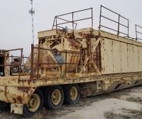 Rusty industrial trailer in an outdoor setting.