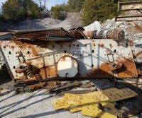 Rusty metal debris in outdoor scrapyard.