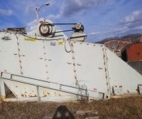 Large industrial machine on grassy field.