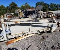 Rusty industrial equipment in outdoor scrapyard.
