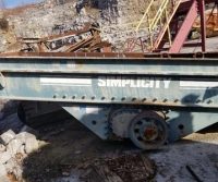 Industrial equipment labeled "Simplicity" in quarry setting.