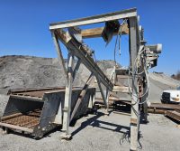 Industrial machinery in a gravel quarry setting.