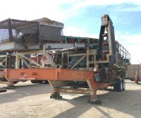Industrial machinery on a flatbed trailer outdoors.