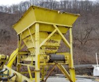 Yellow industrial hopper in a rural area.