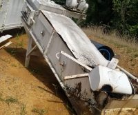 Rusty machinery lying on the ground outdoors.