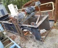 Rusty industrial machinery with chain and motor.