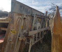 Rusty industrial equipment in outdoor setting.